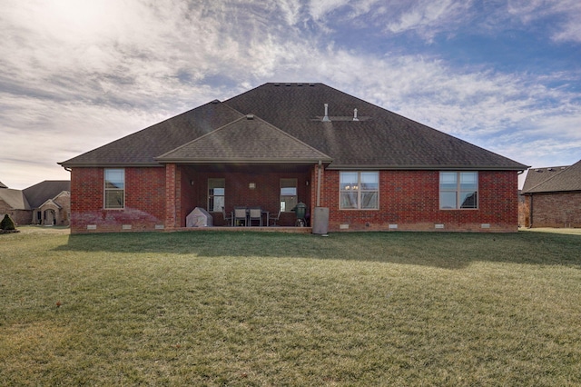 rear view of property with a yard