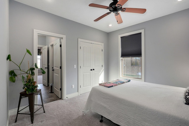 bedroom featuring ceiling fan, multiple windows, a closet, and carpet floors