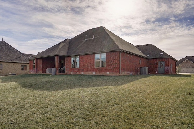 back of property featuring central AC and a yard