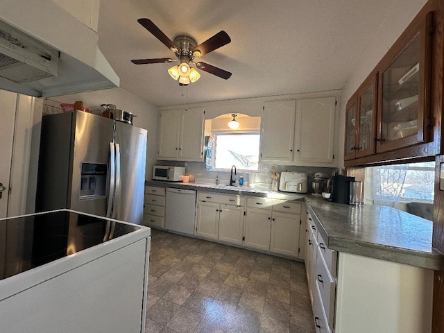 kitchen featuring ceiling fan, sink, white cabinets, extractor fan, and stainless steel appliances