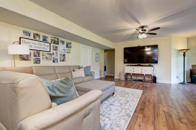 living room with dark hardwood / wood-style floors and ceiling fan