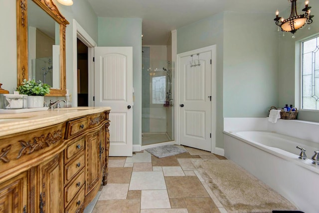 bathroom with vanity, separate shower and tub, and an inviting chandelier