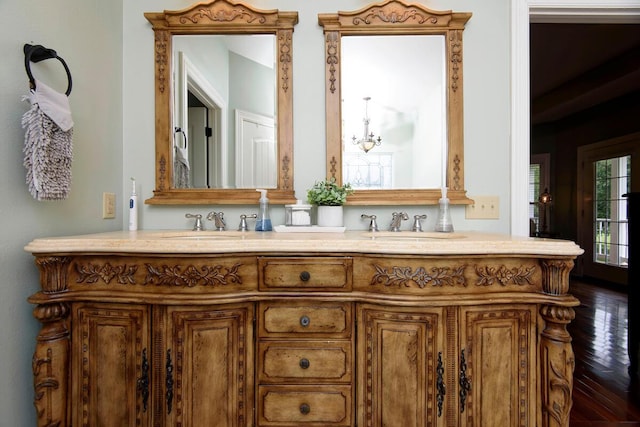 bathroom with vanity, hardwood / wood-style flooring, and a chandelier