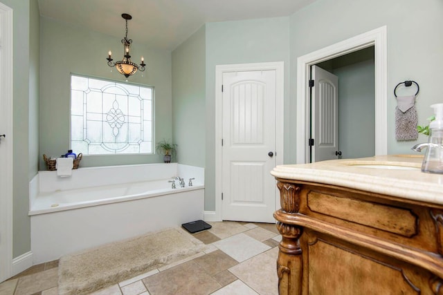 bathroom with vanity, a chandelier, and a washtub