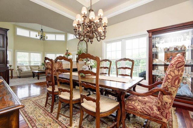 dining area featuring ornamental molding, a chandelier, and wood-type flooring