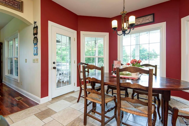 dining space with a notable chandelier