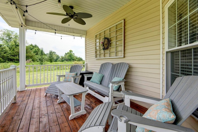 wooden deck featuring ceiling fan