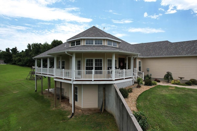 rear view of house featuring a wooden deck and a yard