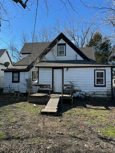 rear view of house featuring a deck