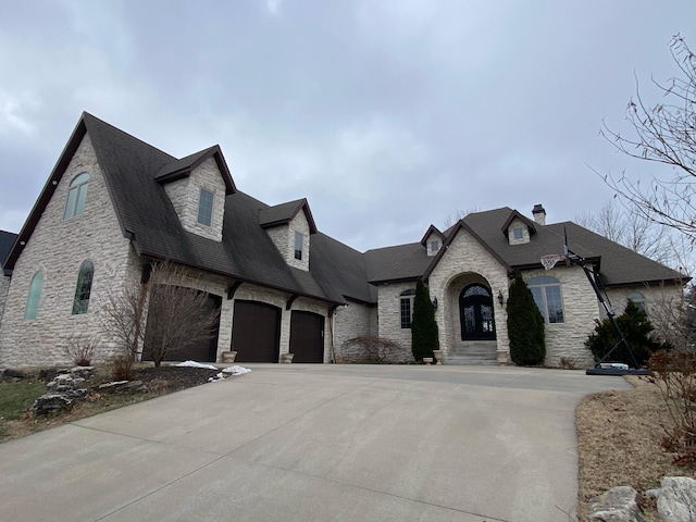 french country inspired facade featuring a garage