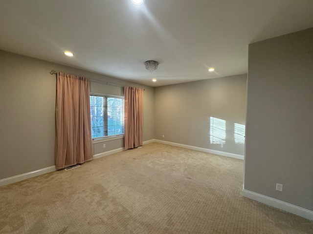 unfurnished room with light colored carpet