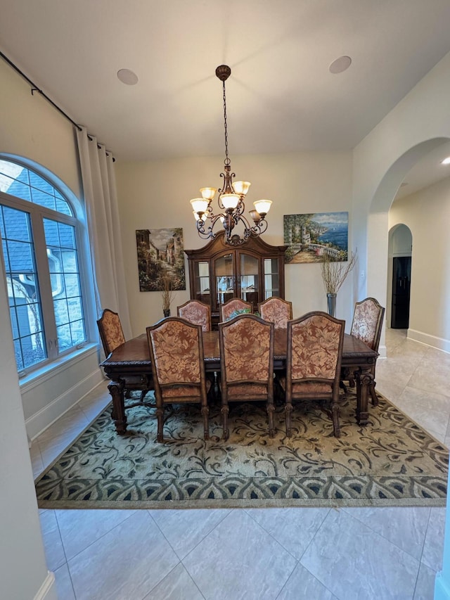 dining area featuring a chandelier and light tile patterned floors