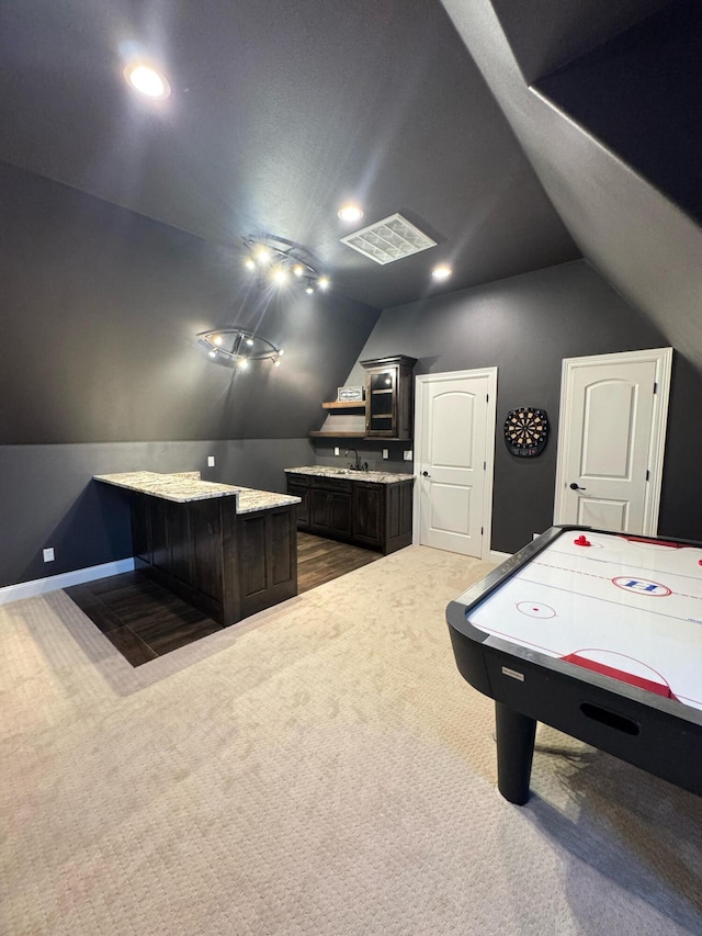 game room featuring sink, vaulted ceiling, and dark carpet