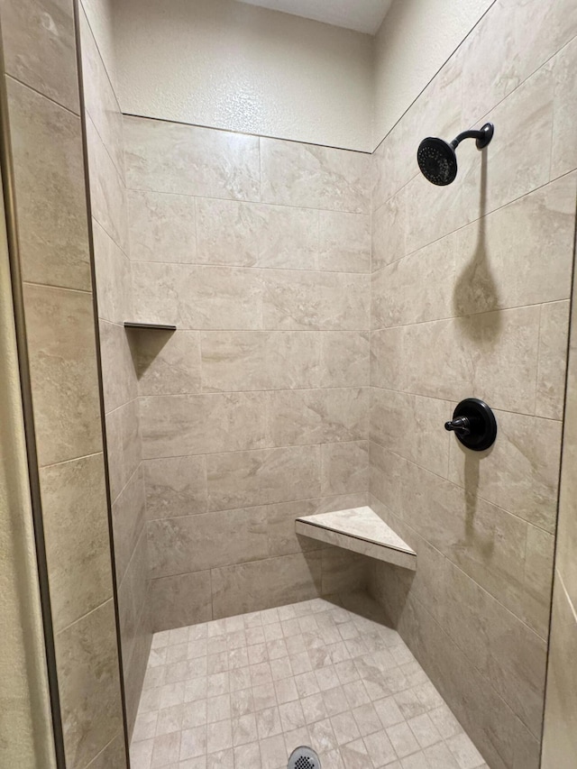 bathroom with a tile shower