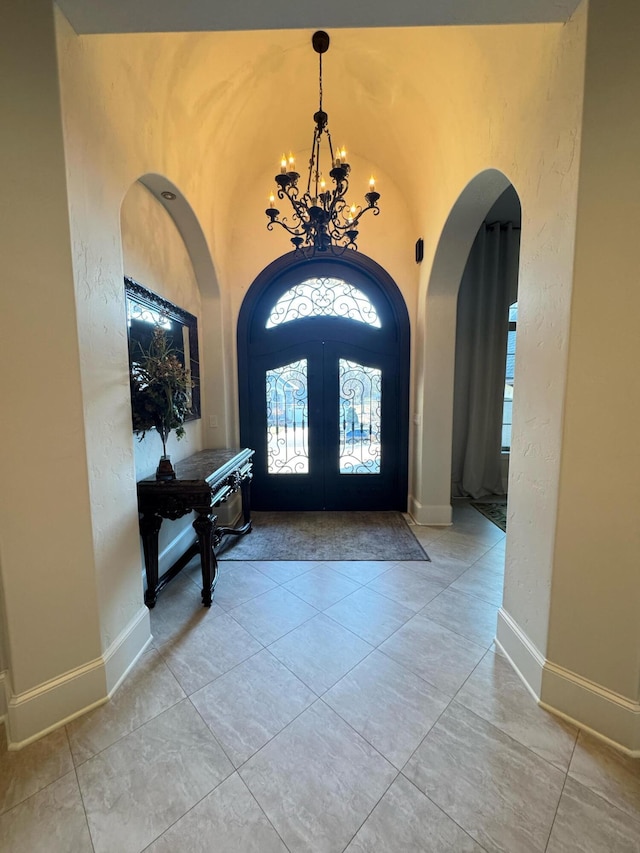 foyer entrance featuring a chandelier and french doors