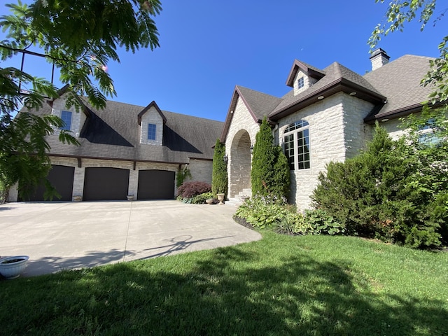 8304 Rolling Hills Dr, Nixa, MO 65714 - view of front of home with stone siding, a garage, driveway, a front lawn, and a shingled roof