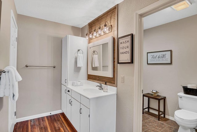 bathroom with toilet and vanity