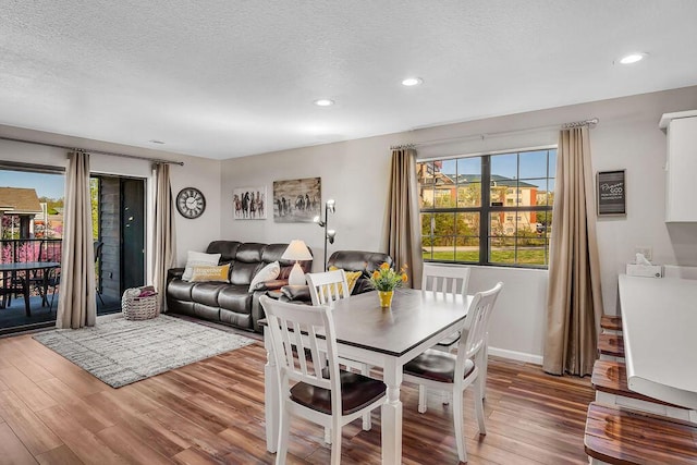 dining area featuring hardwood / wood-style flooring and a textured ceiling