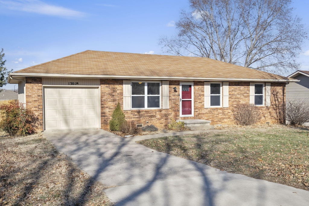 ranch-style home featuring a garage