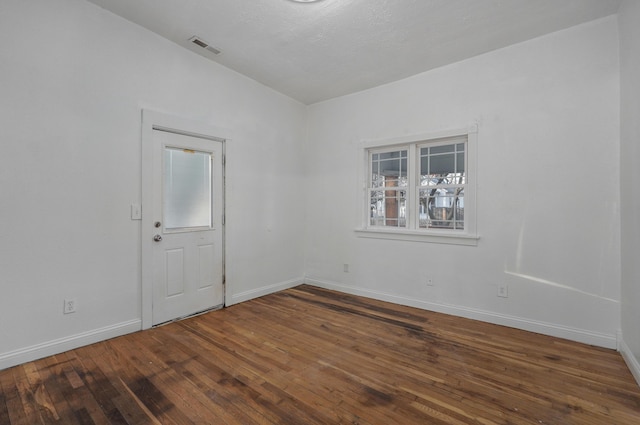 empty room featuring hardwood / wood-style floors and lofted ceiling