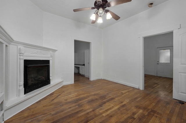 unfurnished living room with ceiling fan and dark hardwood / wood-style floors