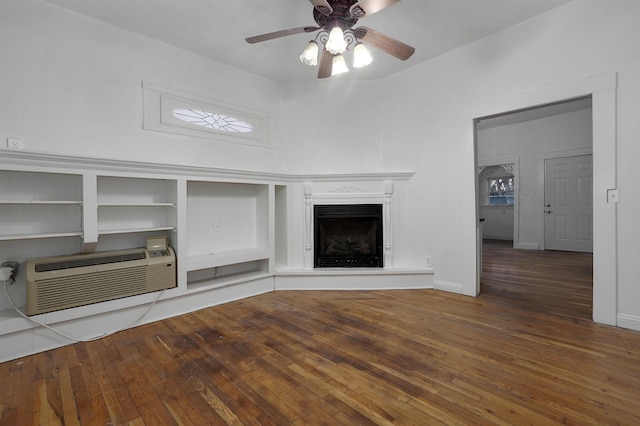 unfurnished living room featuring a wall mounted air conditioner, ceiling fan, and hardwood / wood-style floors