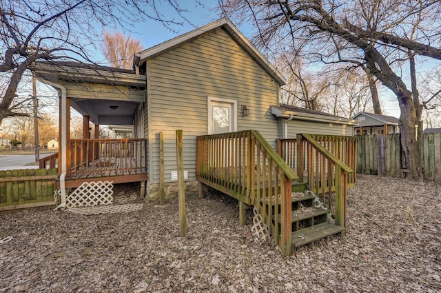 back of property featuring a wooden deck