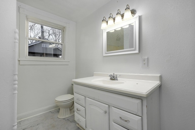 bathroom featuring toilet and vanity