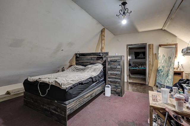 bedroom with vaulted ceiling and dark colored carpet