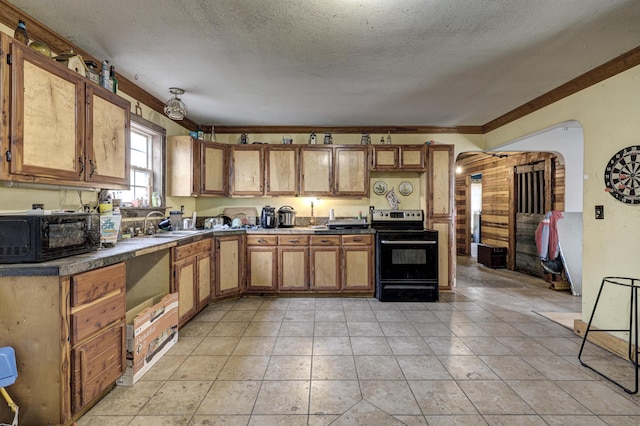 kitchen with a textured ceiling, sink, ornamental molding, range with electric stovetop, and light tile patterned floors