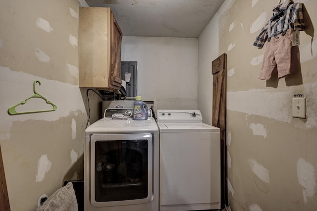 washroom featuring washer and clothes dryer and cabinets