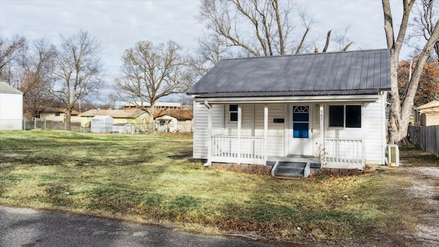 exterior space with covered porch and a front lawn