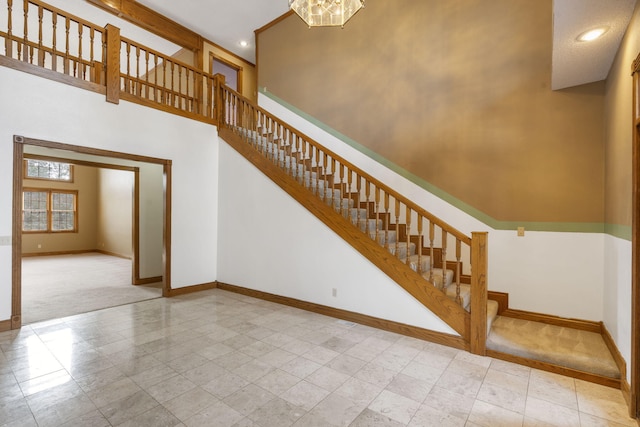 stairs featuring a high ceiling