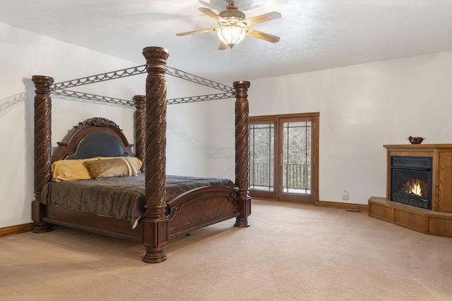 bedroom featuring access to exterior, a textured ceiling, carpet floors, and ceiling fan