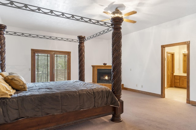 bedroom featuring ensuite bath, access to outside, light colored carpet, and ceiling fan