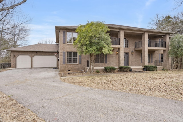 view of front of house featuring a balcony and a garage