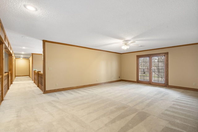 carpeted spare room featuring ceiling fan, ornamental molding, french doors, and a textured ceiling