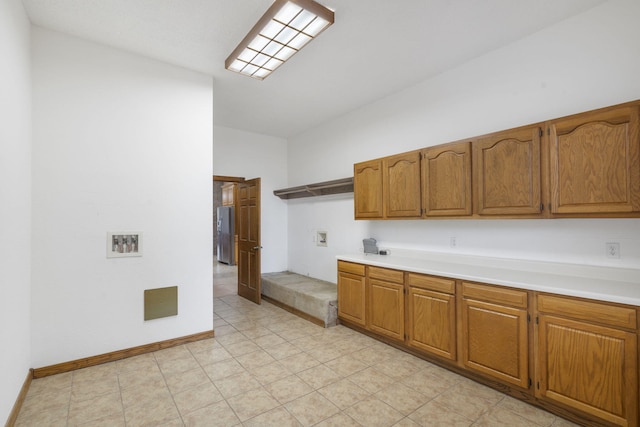 kitchen with stainless steel fridge with ice dispenser and vaulted ceiling