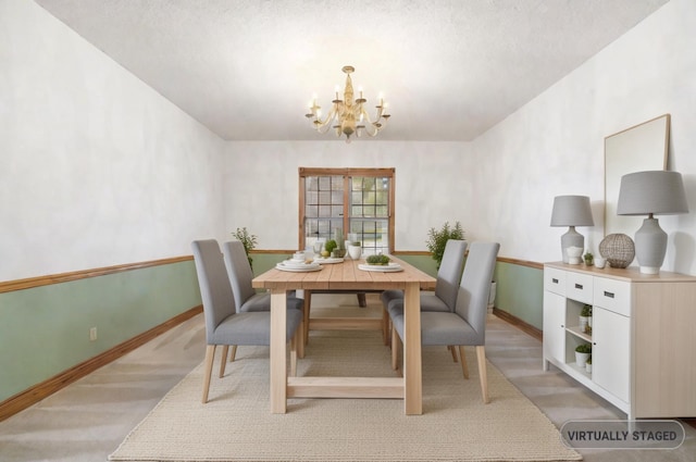 dining space featuring a textured ceiling and an inviting chandelier