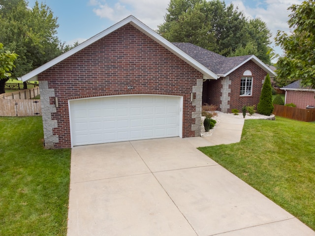 ranch-style home with a garage and a front yard