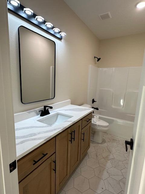 full bathroom with toilet,  shower combination, tile patterned flooring, and vanity