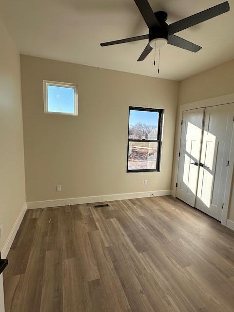 spare room with ceiling fan and hardwood / wood-style floors