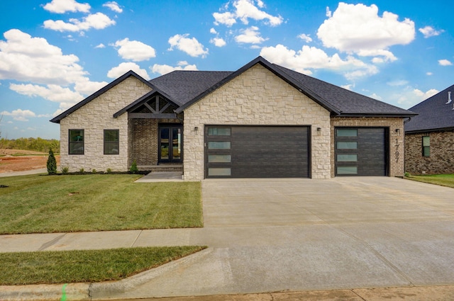 1797 E Cobblestone Dr, Ozark, MO 65721 - view of front of property featuring an attached garage, stone siding, concrete driveway, a front lawn, and french doors
