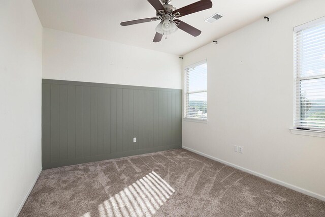 unfurnished room with ceiling fan and light colored carpet