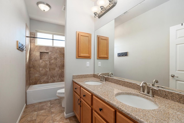 full bathroom featuring toilet, tiled shower / bath, and vanity