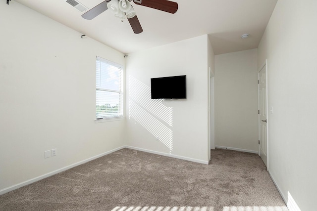 empty room with ceiling fan and light colored carpet