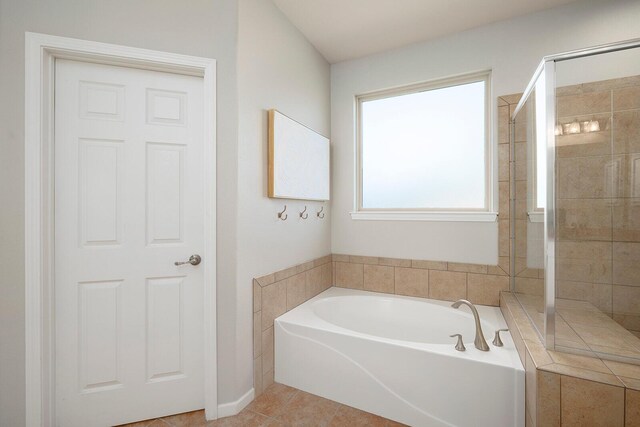 bathroom with independent shower and bath and tile patterned floors