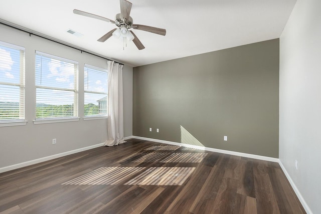 unfurnished room with ceiling fan and dark hardwood / wood-style flooring