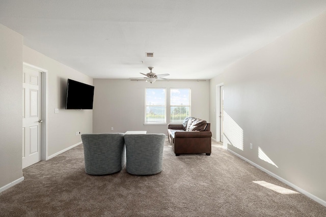 living area with carpet floors and ceiling fan