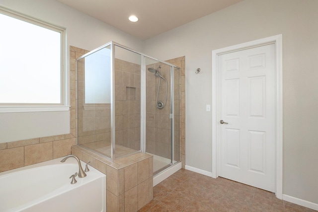 bathroom with separate shower and tub and tile patterned flooring